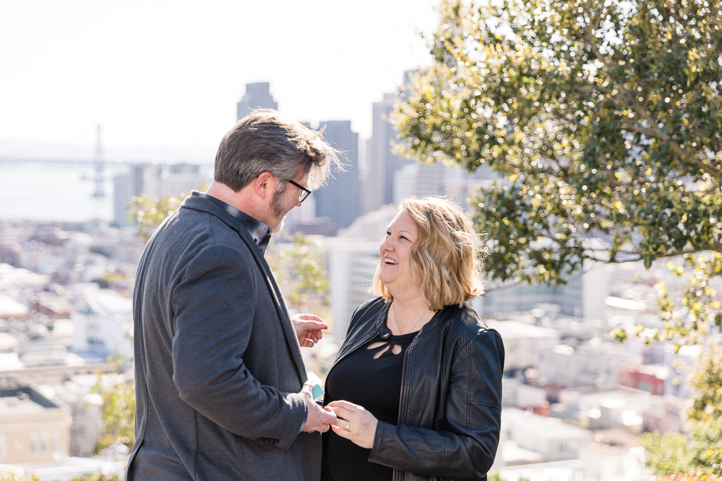 getting engaged in front of San Francisco skyline backdrop