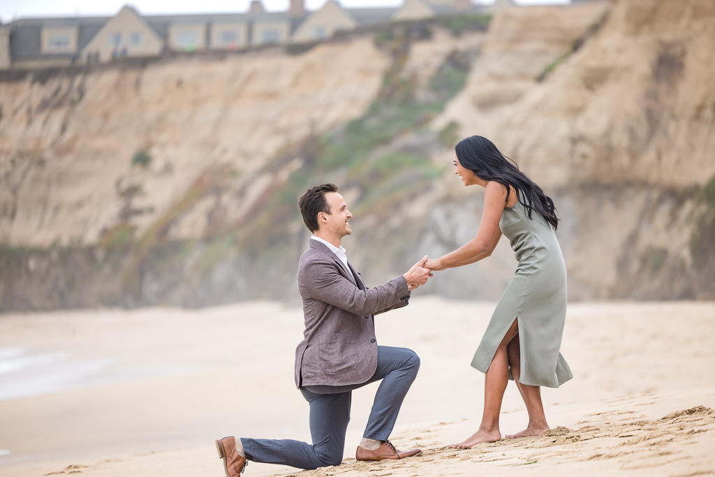 happy surprise proposal reaction on Ritz-Carlton beach in Half Moon Bay