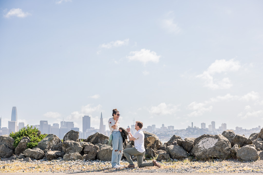 Treasure Island surprise proposal with San Francisco skyline in the background