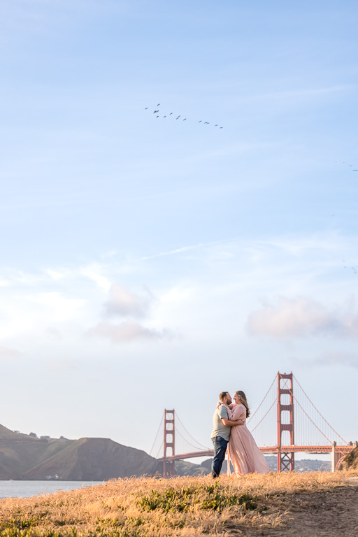 colorful golden engagement photos at the Golden Gate Bridge