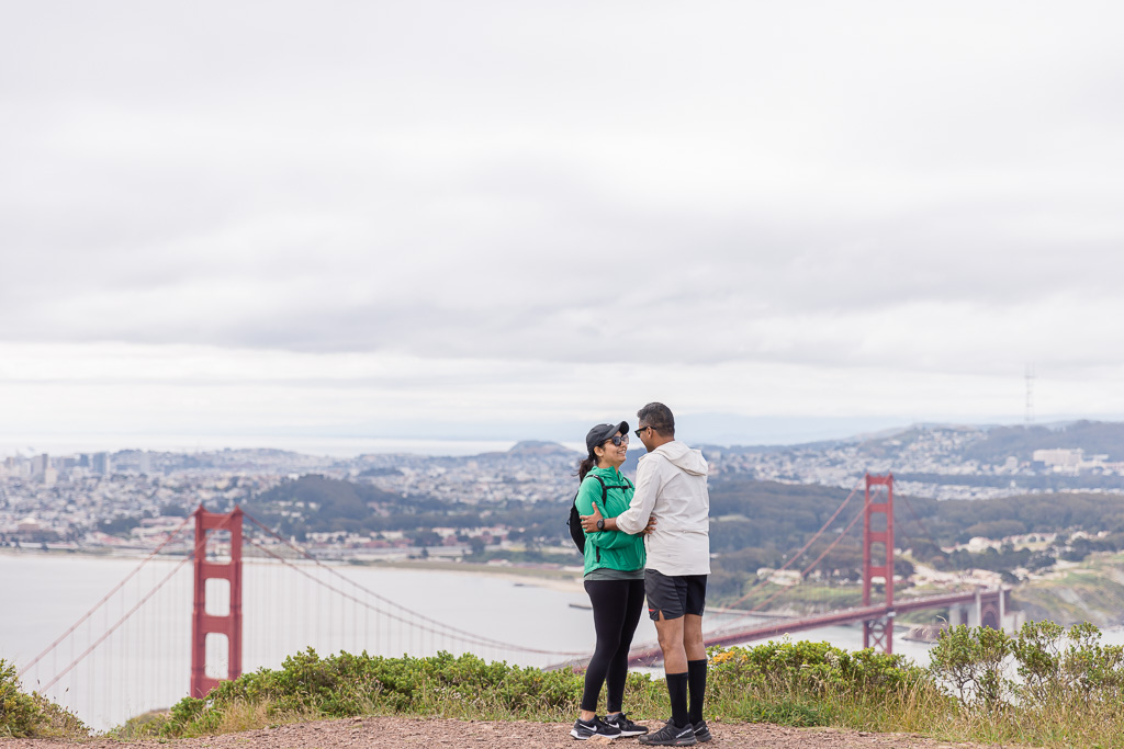 couple standing on hill overlooking Bay Area