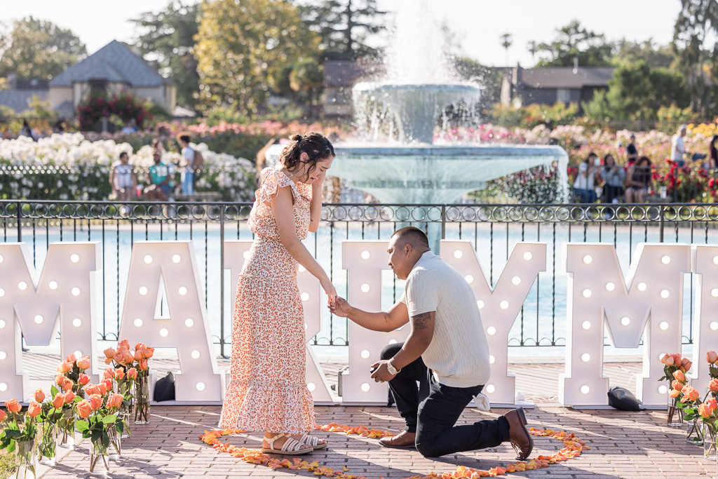San Jose Rose Garden surprise proposal in front of the fountain with marry me letters