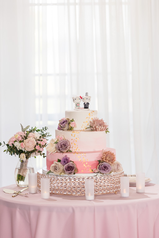 wedding cake with floral decor and bouquet next to it