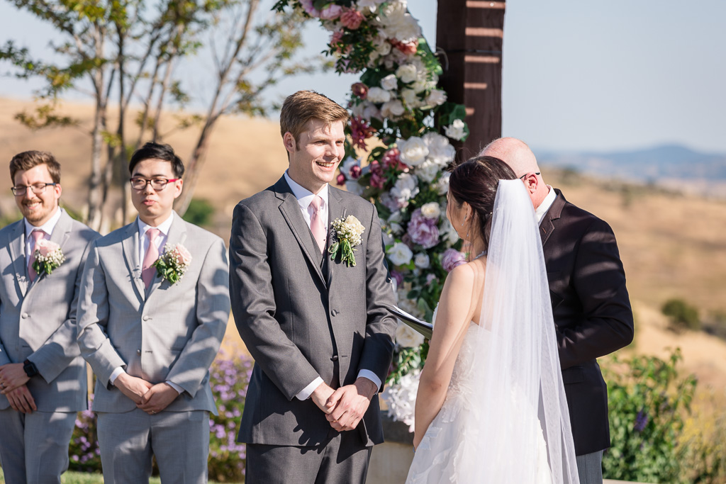 groom sharing a laugh with the bride during the ceremony