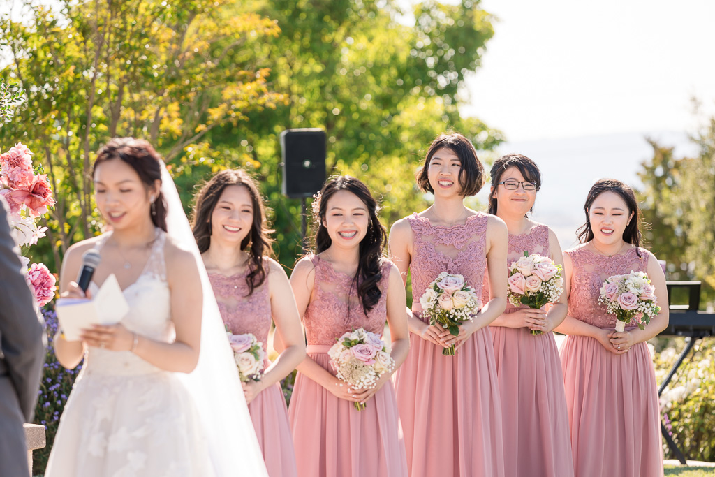 bridesmaids having a funny moment during ceremony