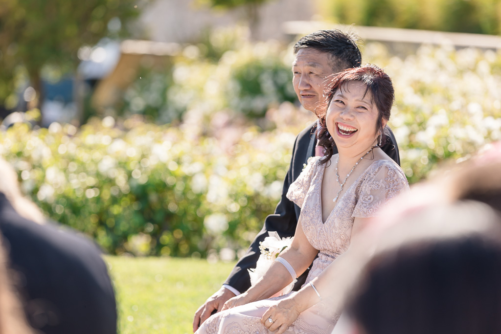 bride’s parents laughing during an enjoyable moment of the wedding ceremony
