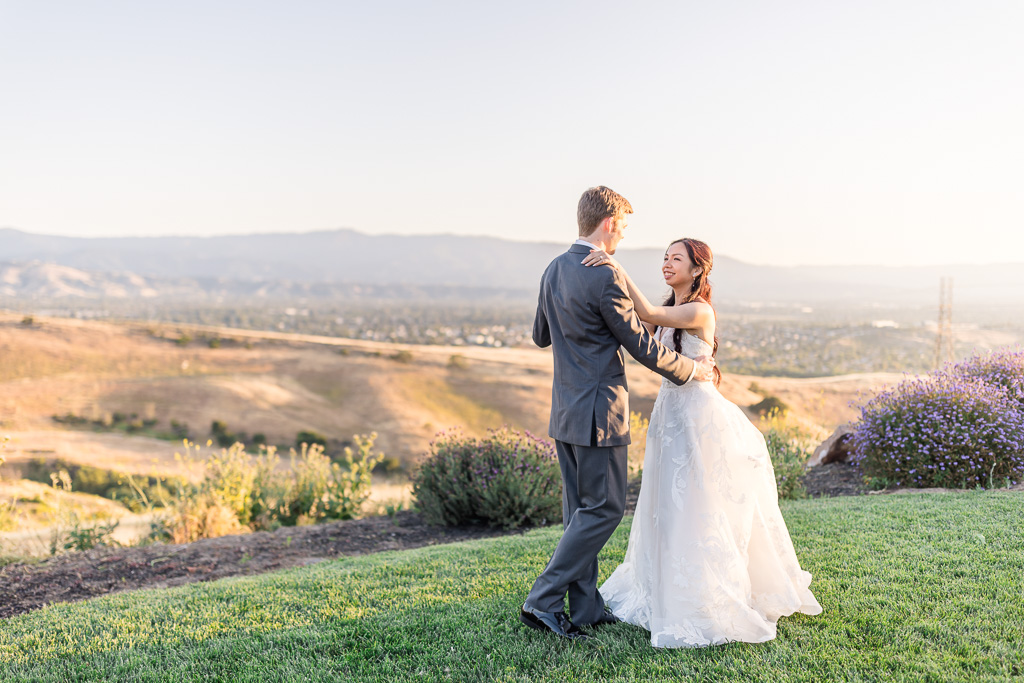 bride and groom practicing their first dance alone outside by themselves at sunset