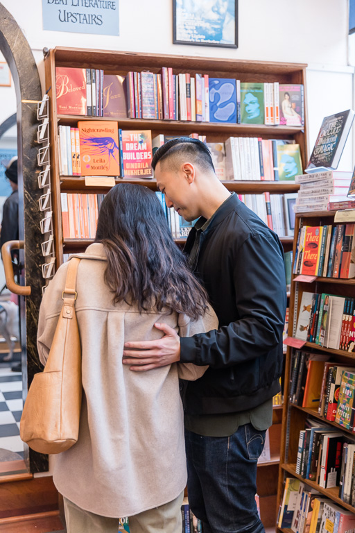 couple reading a book in a bookstore