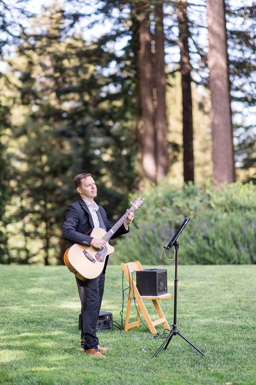 Christopher Nicklin playing guitar at a wedding ceremony