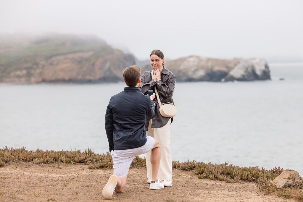 surprise proposal atop cliffs by the ocean