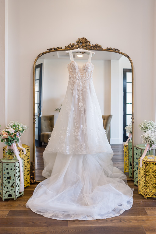 dress hanging on bridal suite mirror