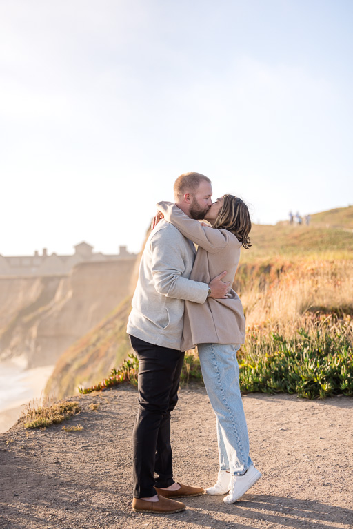 couple kissing on the cliffs of Half Moon Bay