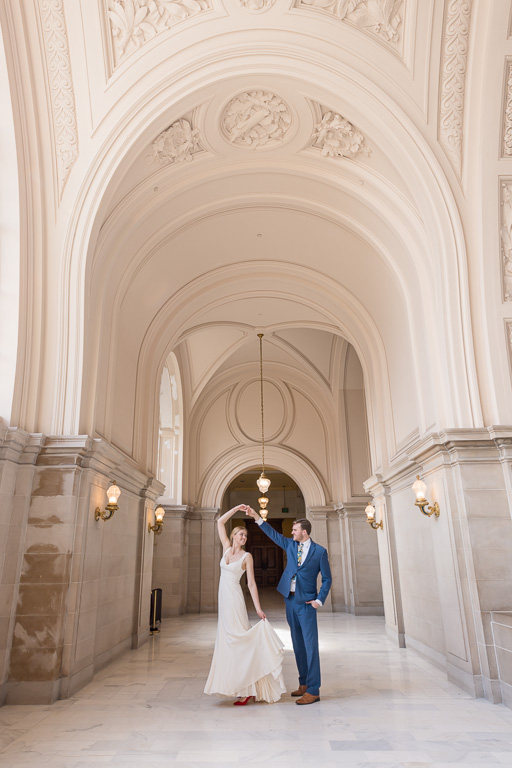 bride and groom doing a little dance at SF City Hall