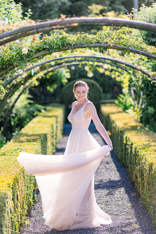 bride spinning with her dress in a sunny garden