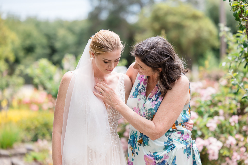 bride and mother of the bride sharing a moment together