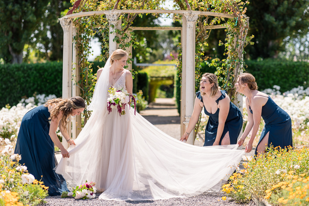 bridesmaids laying out bride's dress