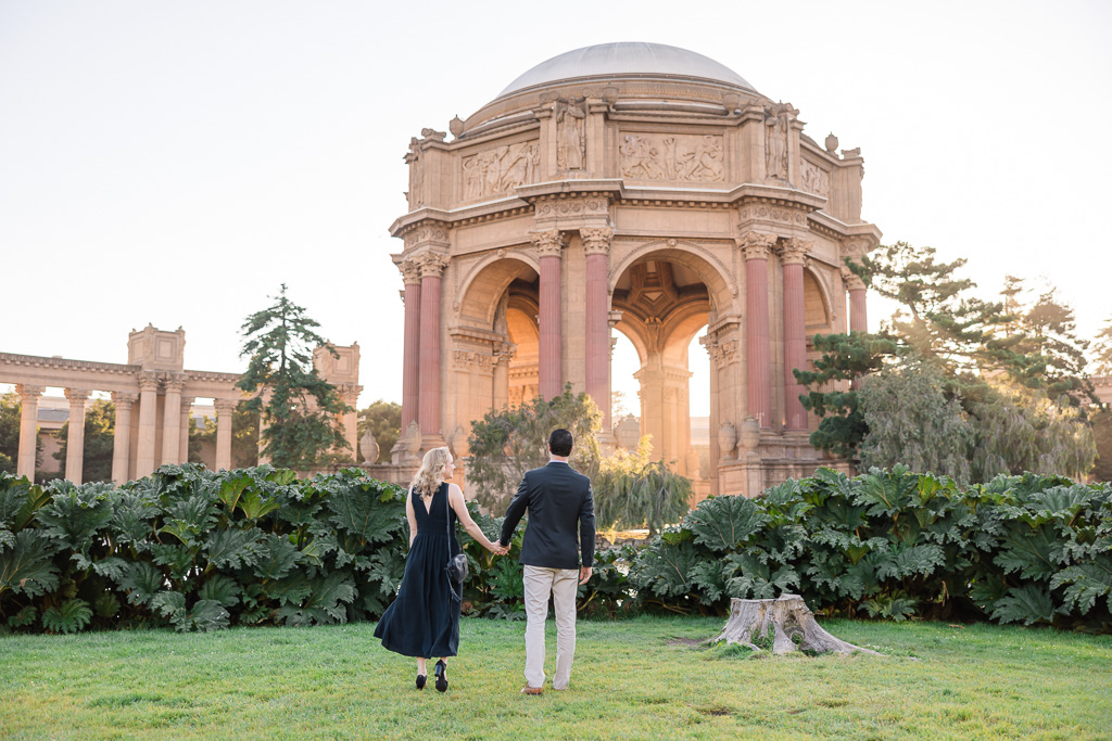 couple standing at the Palace of Fine Arts facing away from the camera