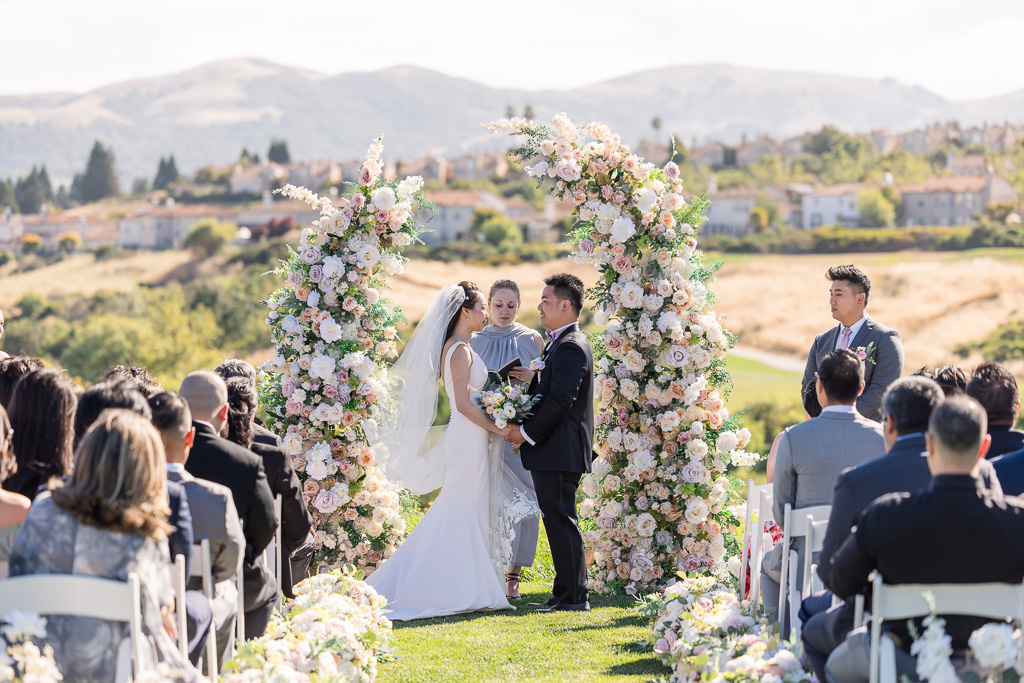 wedding ceremony with split floral arch backdrop