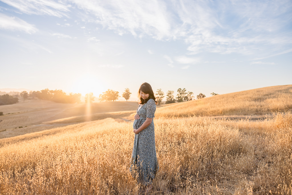 mommy-to-be maternity photos at golden hour on a hill