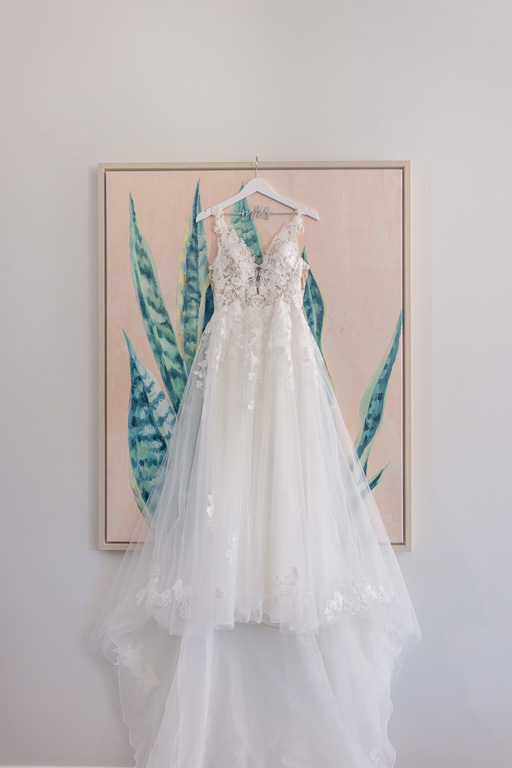 wedding dress hanging up on a painting