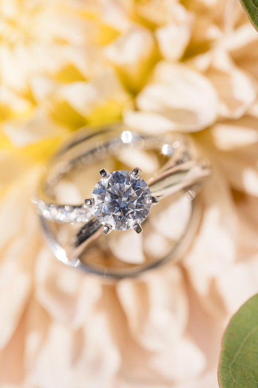 wedding and engagement ring close-up on yellow flowers