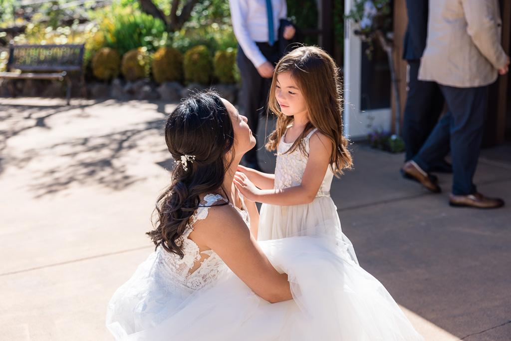 bride with flower girl in white dress