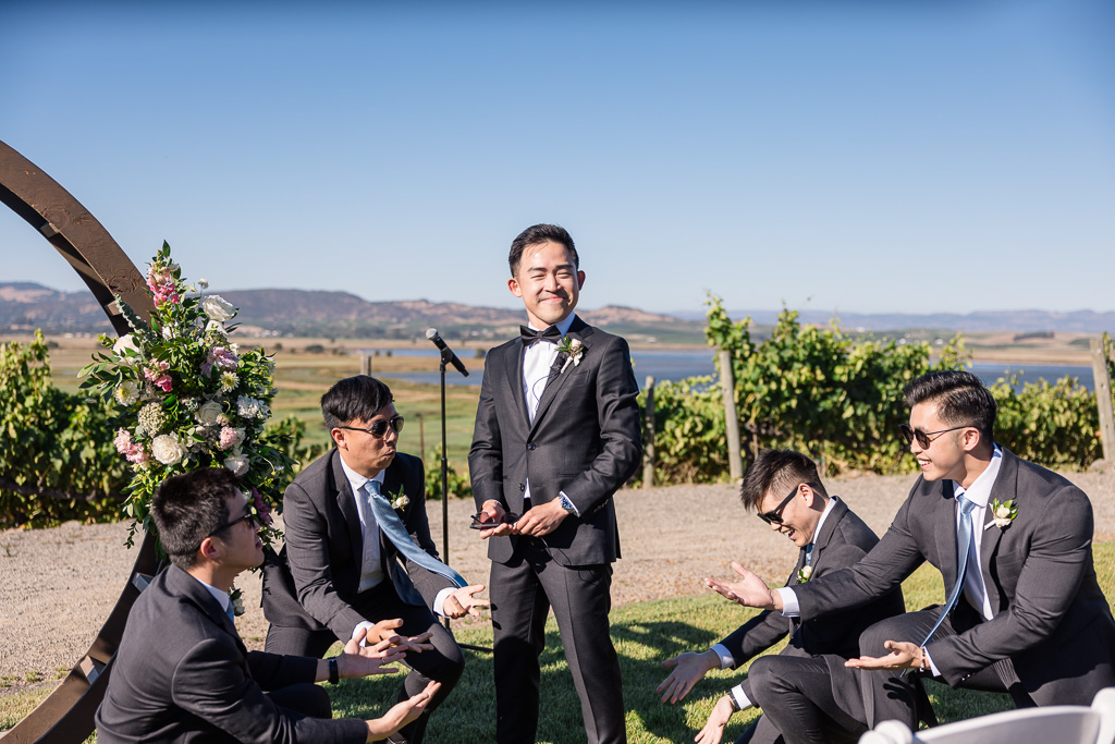 groomsmen and groom giving a dance performance during wedding ceremony processional