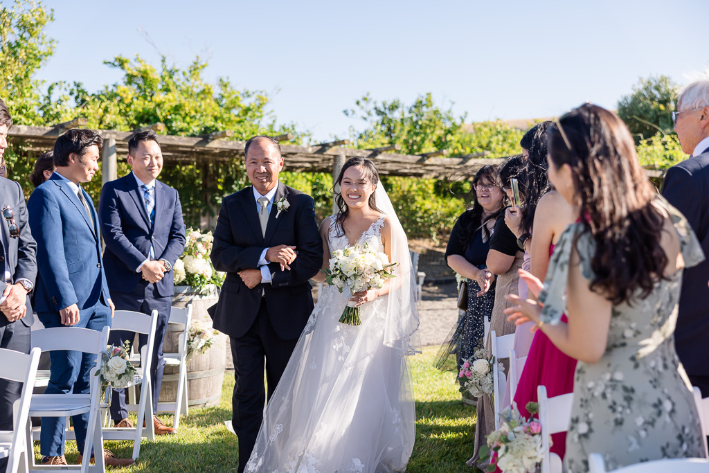 bride and dad walking into wedding ceremony at Viansa's upper lawn
