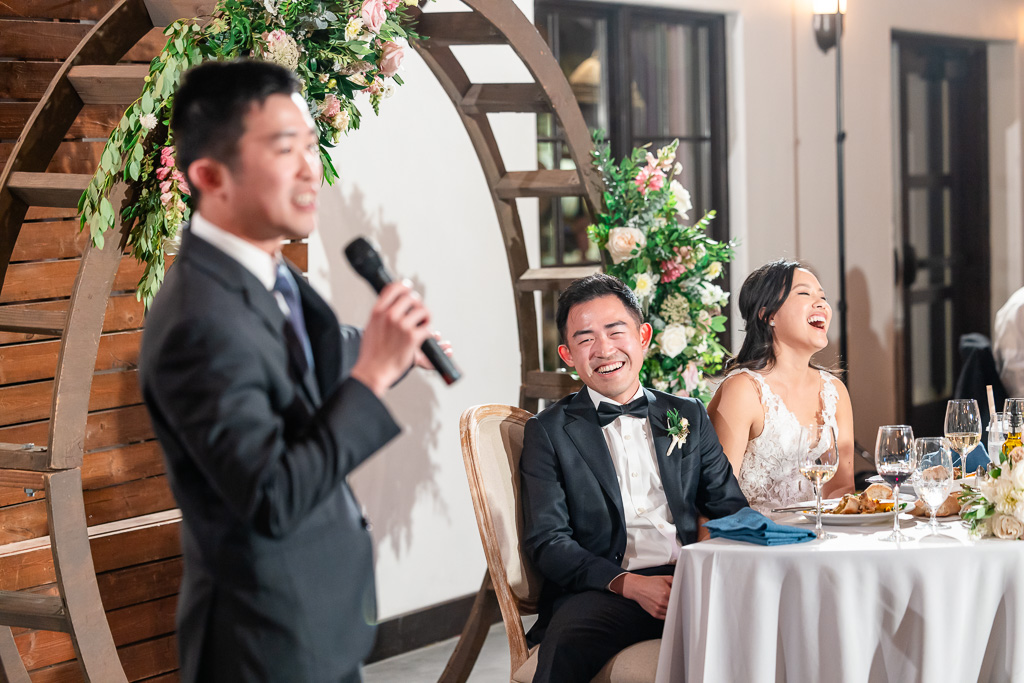 bride and groom reacting to a funny speech