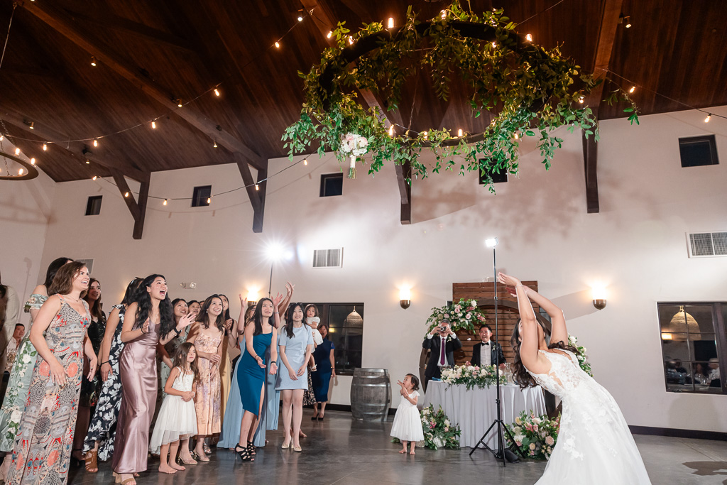 bouquet flying through the air at indoor reception