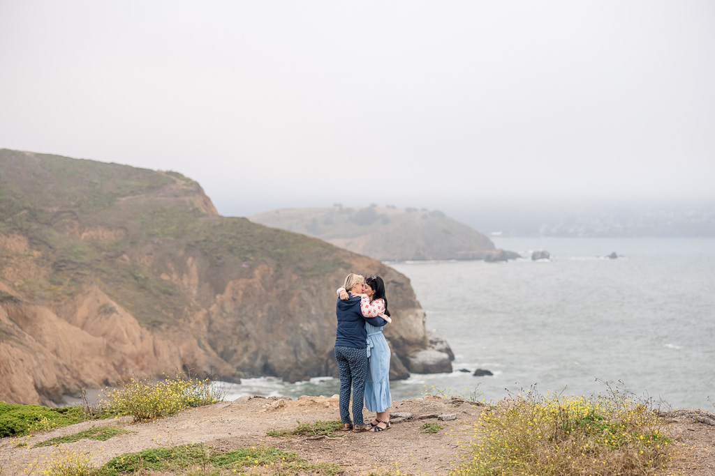 couple hugging by the ocean