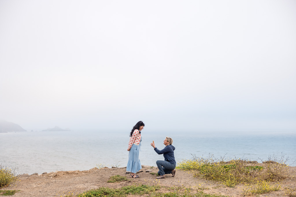 marriage proposal with foggy ocean backdrop