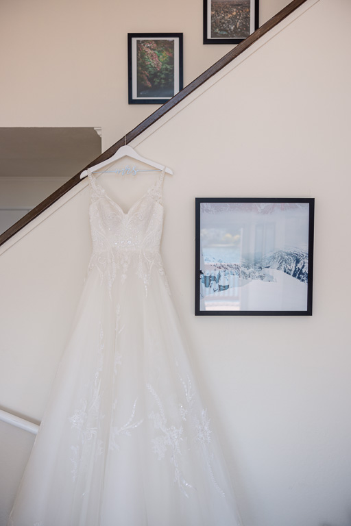 wedding dress handing on a slanted staircase