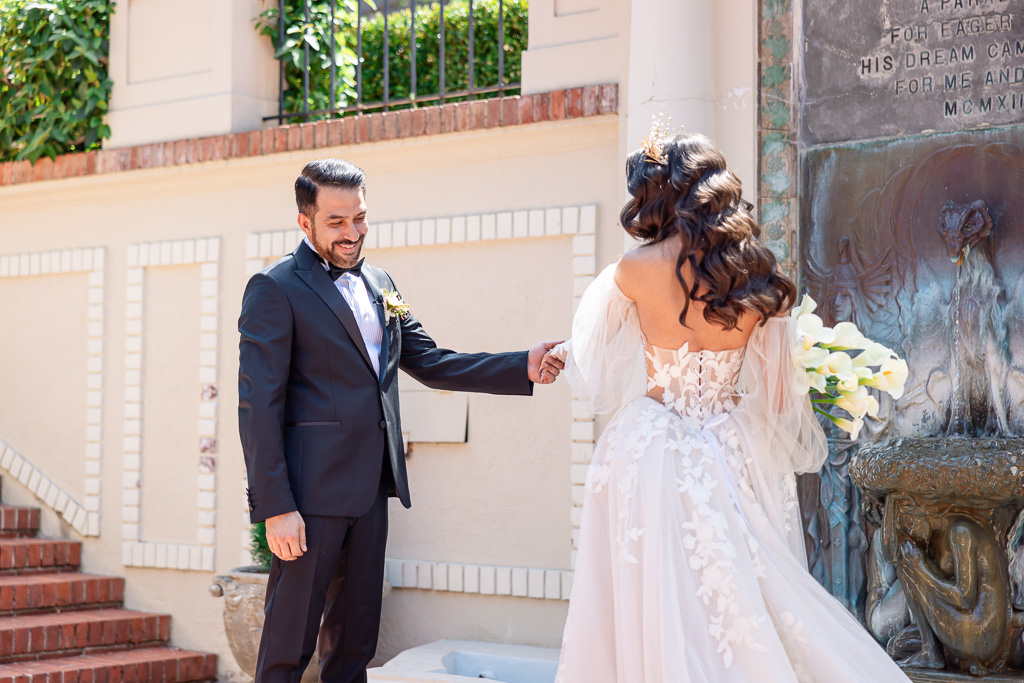 groom adores his bride during their first look