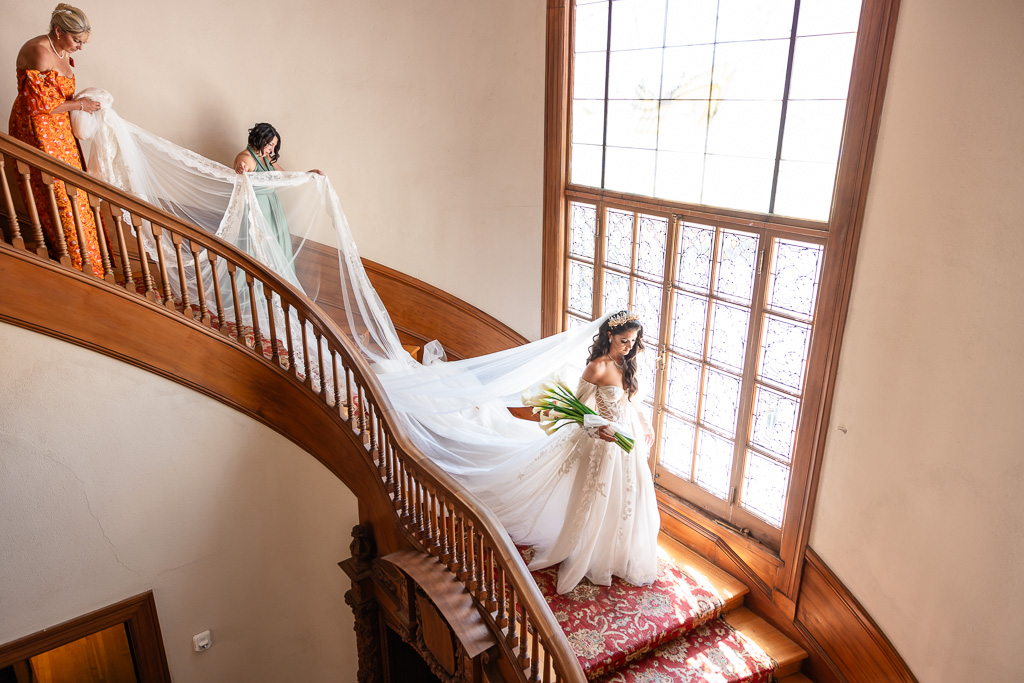 bride with 24 ft long veil walking down Villa Montalvo grand staircase