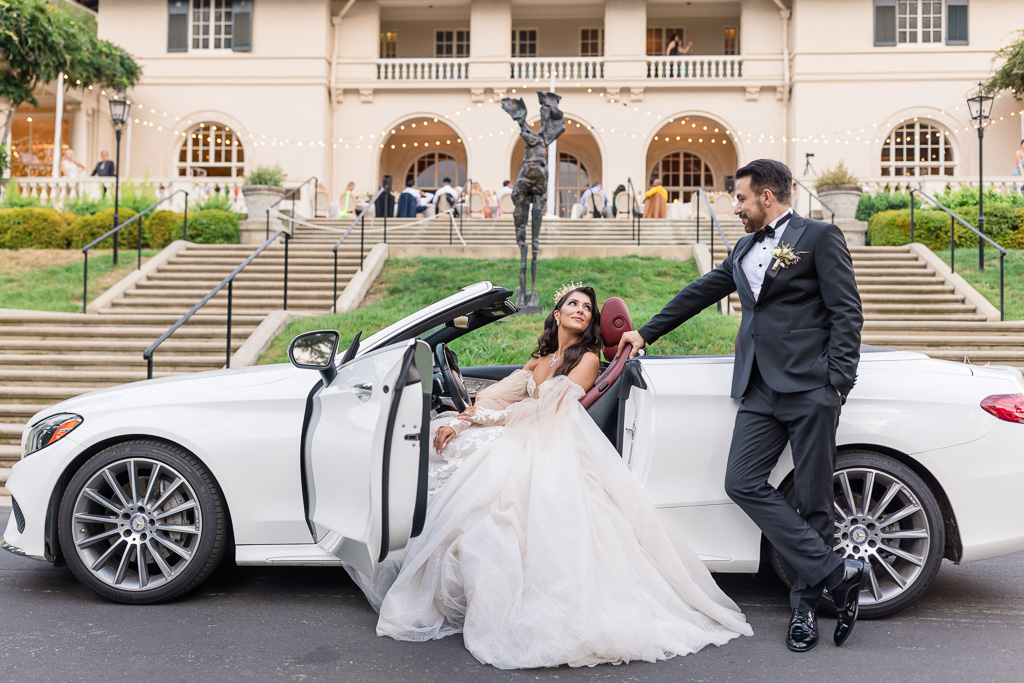bride sits in her convertible in front of Villa Montalvo