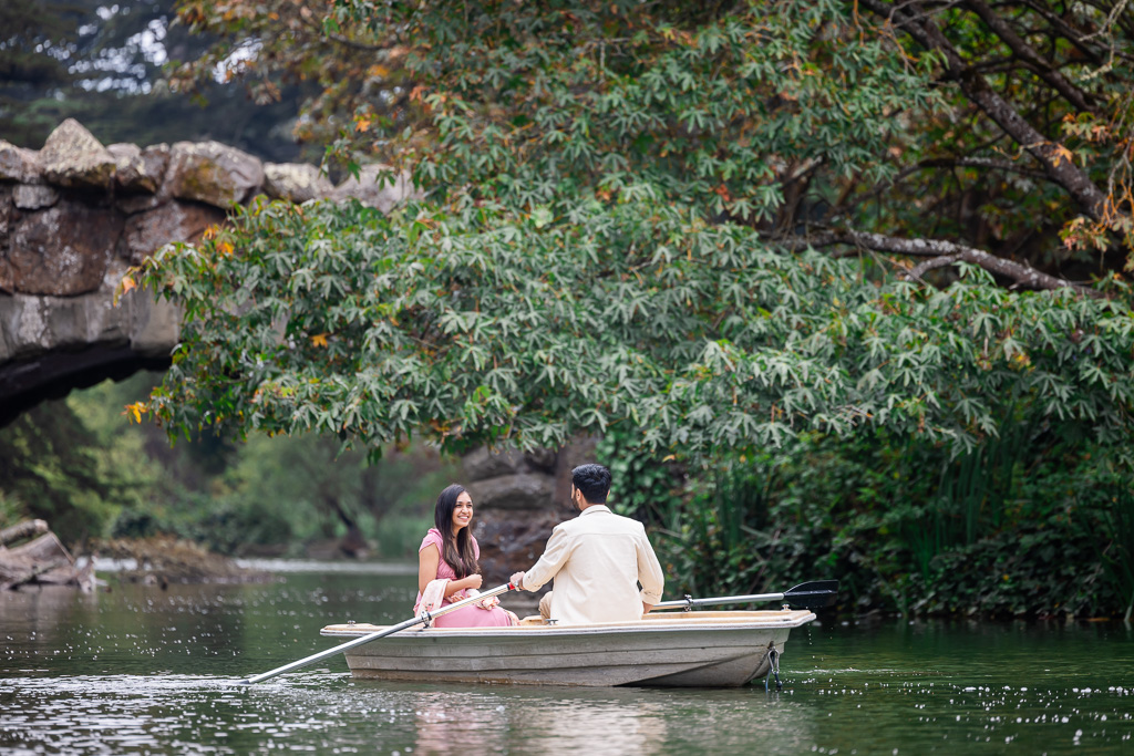 happy couple rowing on Stow Lake