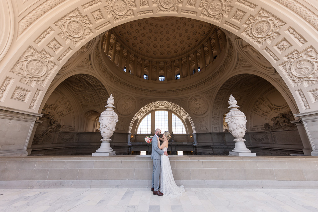 couple portrait under arch at San Francisco City Hall