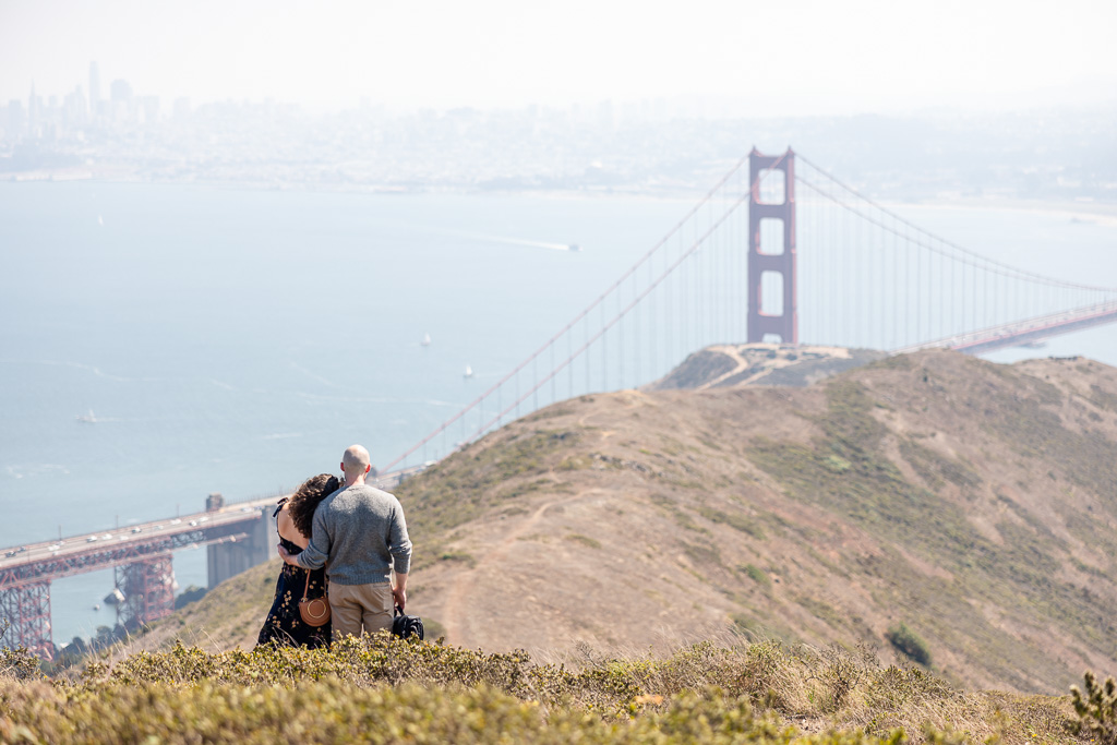 couple standing together looking at the Golden Gate Bridge
