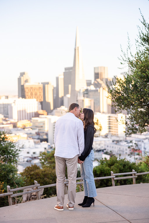 paparazzi photography of couple looking at downtown San Francisco at sunset