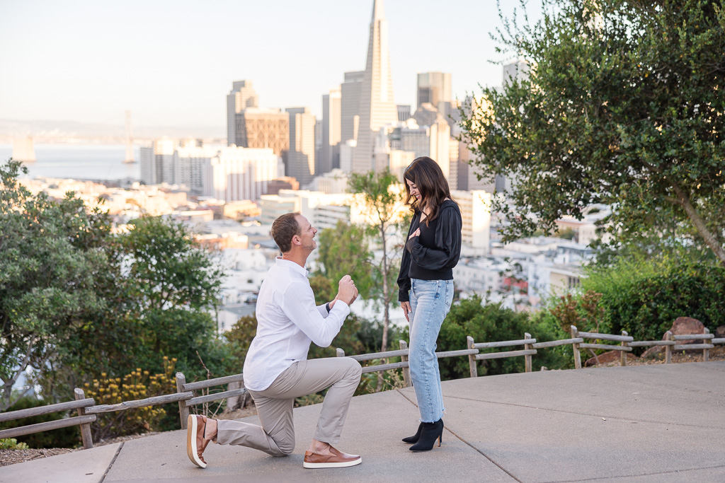 paparazzi-style stealthy photo of San Francisco Ina Coolbrith Park engagement during golden hour