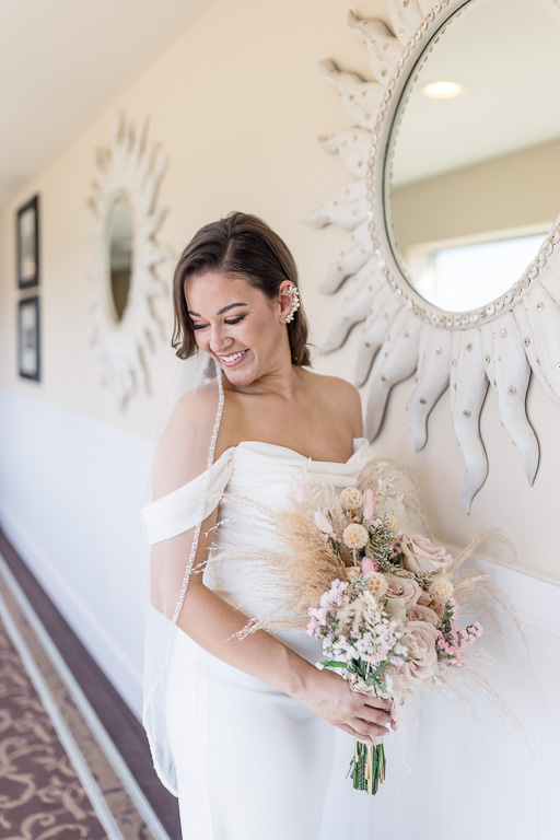 solo portrait of bride holding her bouquet at Oceano Hotel