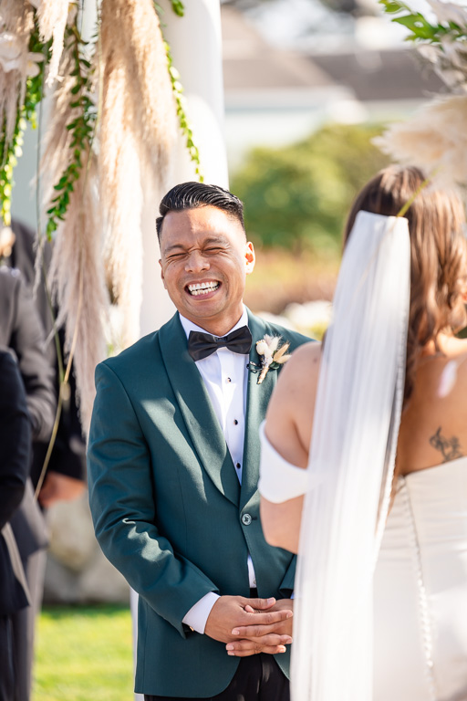 groom laughing during some funny vows
