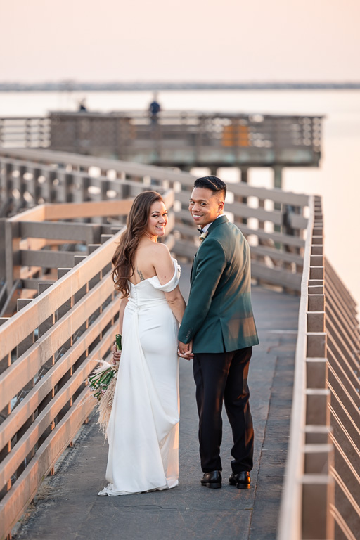a newlywed couple on an ocean pier
