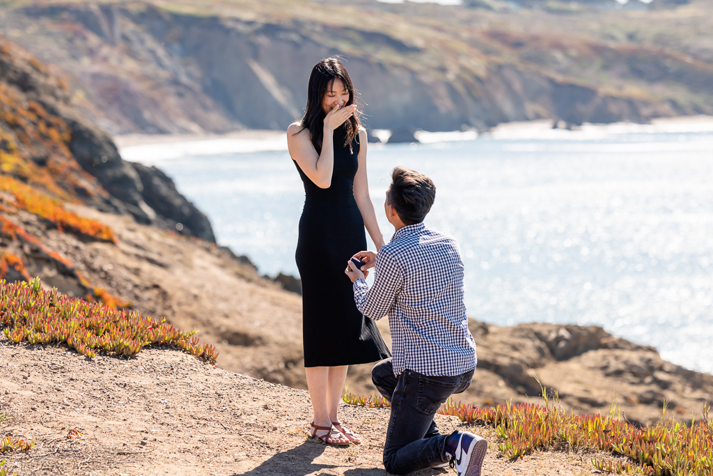 cute surprised reaction to marriage proposal at the cliffs above Rodeo Beach