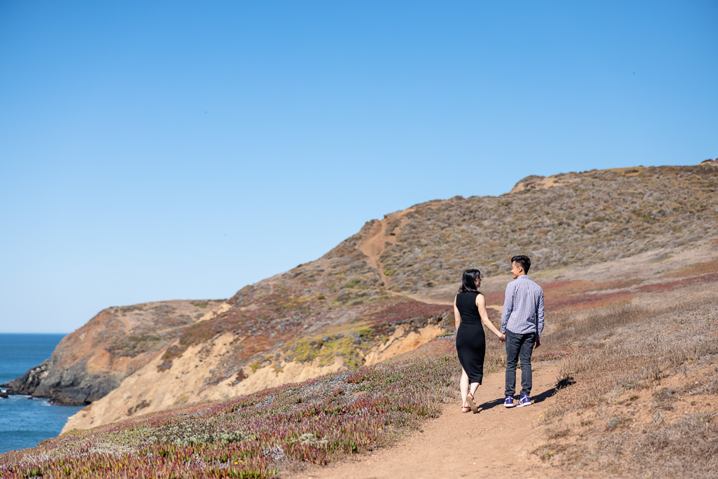 couple walking along coastal trail