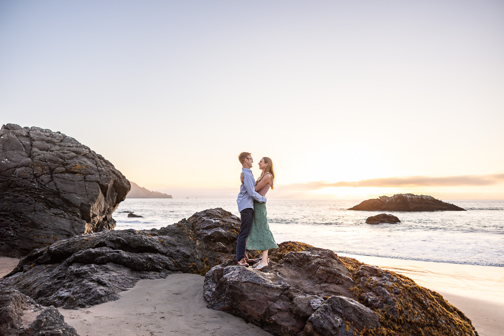 engagement photo on the rocks at the beach