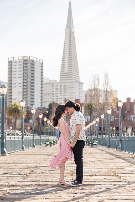 sunny sunset engagement session with San Francisco downtown skyline backdrop