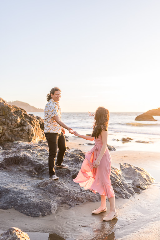 sunset engagement session on rocks at the beach