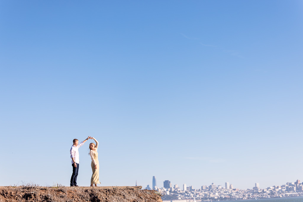 engagement photos with San Francisco downtown skyline in the background